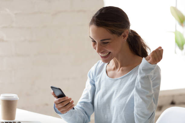 istock Overjoyed young mixed race lady received sms with good news. 1200214123