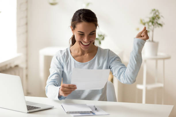 istock Overjoyed millennial mixed race female worker celebrating special achievement. 1200214134