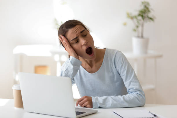 istock Tired young mixed race female worker yawning. 1200214141