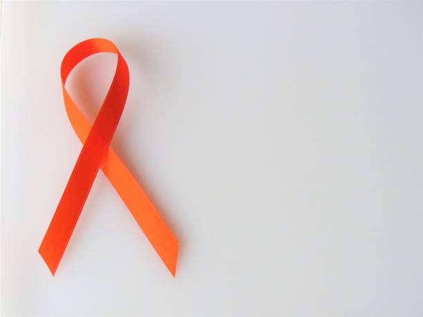Orange ribbon--Awareness month: leukemia; multiple sclerosis Orange ribbon--Awareness month: leukemia; multiple sclerosis. White background. Copy Space. Christine Kohler stock pictures, royalty-free photos & images