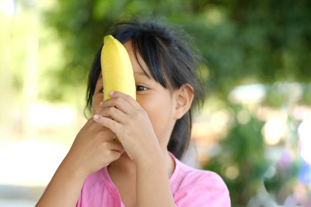 Eighteen month old girl lifestyle shoot eating banana