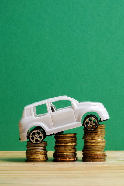 istock Miniature car on coin stack. Auto trasportation conceptual. 1200218877
