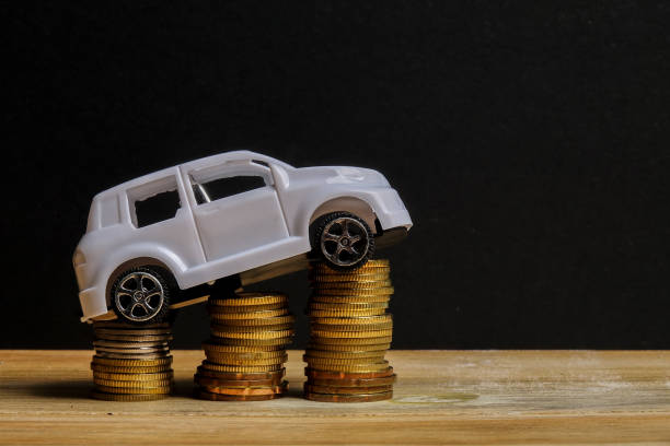 istock Miniature car on coin stack. Auto trasportation conceptual. 1200218887