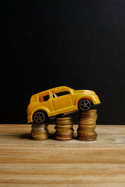 istock Miniature car on coin stack. Auto trasportation conceptual. 1200218899
