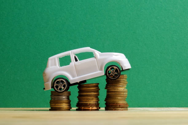 istock Miniature car on coin stack. Auto trasportation conceptual. 1200218902