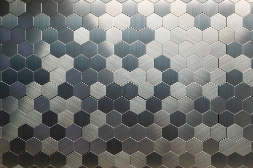 Background of metal honeycomb. Hexagons made of metal. Metallic texture.