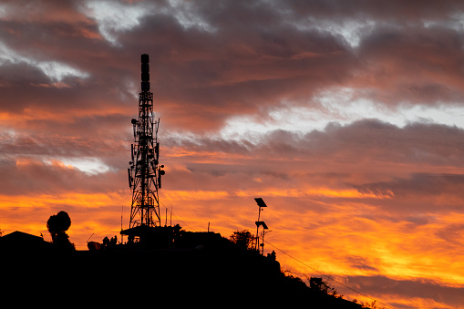 A cell phone tower or communications tower in the early morning sunrise.