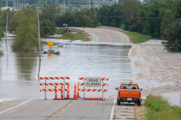 Flooded Roads Flooding causes closures on a rural Iowa road. truck in rain stock pictures, royalty-free photos & images