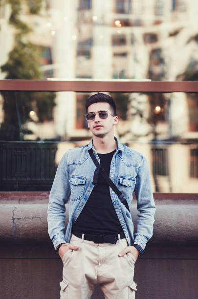 istock Young man wearing denim shirt 1200237879