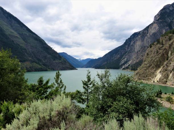 istock Lake surrounded of mountains 1200238775