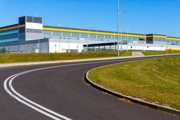 istock Drive way to large distribution warehouse building 1200268626