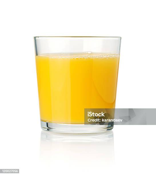 Tumbler Glass Of Orange Juice Resting On A White Surface Stock Photo - Download Image Now