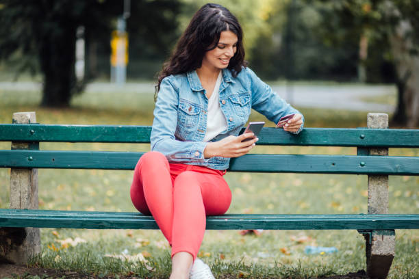 istock Young lady sitting alone on the bench 1200271763