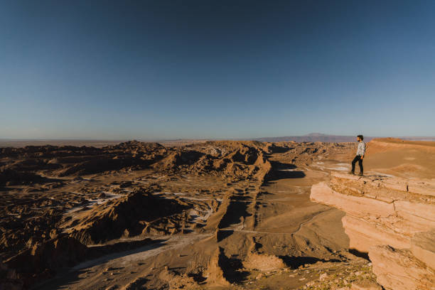 istock Man standing and looking at Valle de la Luna in Atacama desert 1200272767