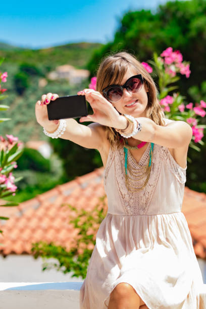 istock Cute young woman using cellphone on the street. 1200273646