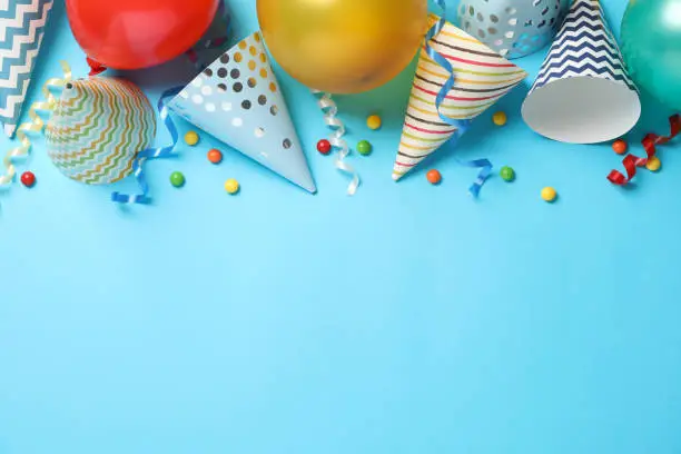 Photo of Composition with different birthday accessories on blue background, space for text