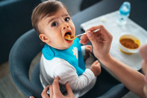 istock Mother feeding her baby boy 1200281884