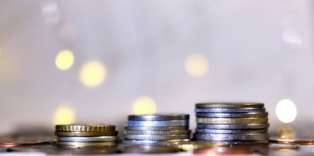 istock Coins stacked in stacks on a colored background with a side 1200284841