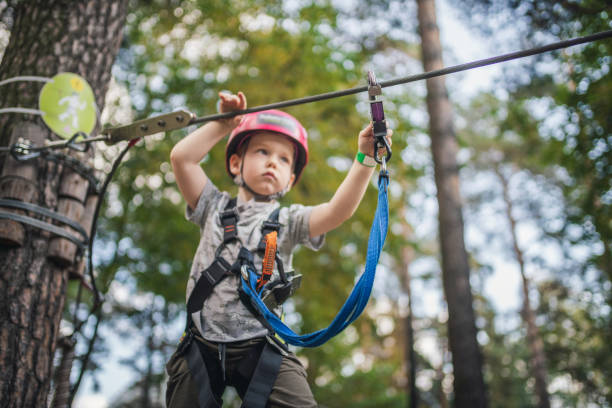istock Cute little boy goes through an obstacle course in an adventure park 1200287106