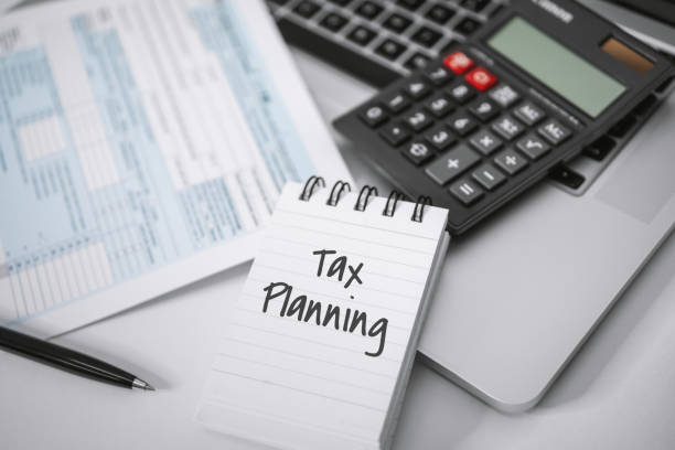 istock Notebook, Calculator and Income Tax Form. 1200287188