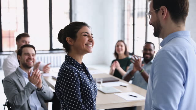 Confident proud indian employee of month handshaking company boss