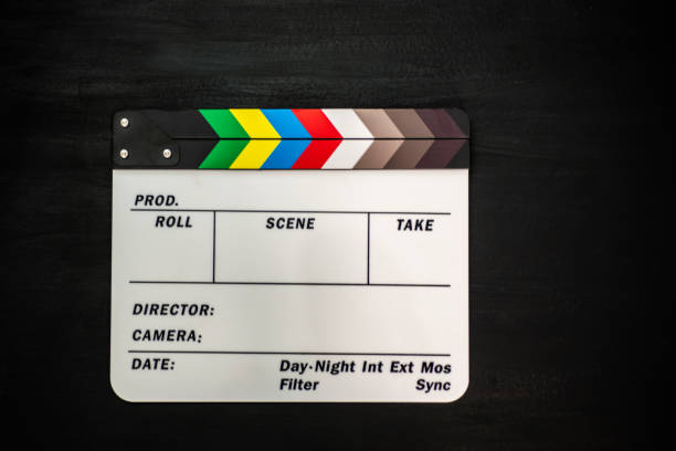 istock Filmmaker profession. Clapperboard on wooden black background top view copyspace 1200288794
