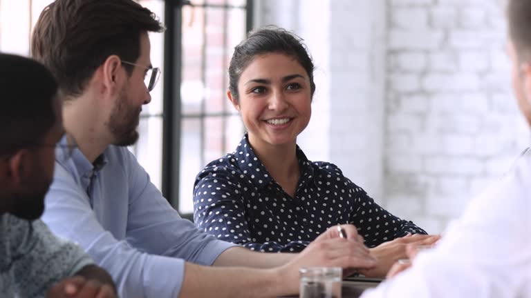 Smiling indian hr member talking to job applicant during interview