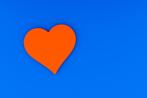 Red heart on a blue background, a symbol of love.3D rendering.