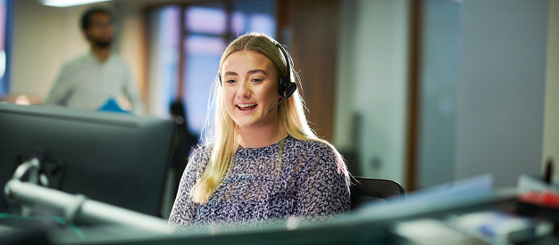 a female call center worker takes a call.