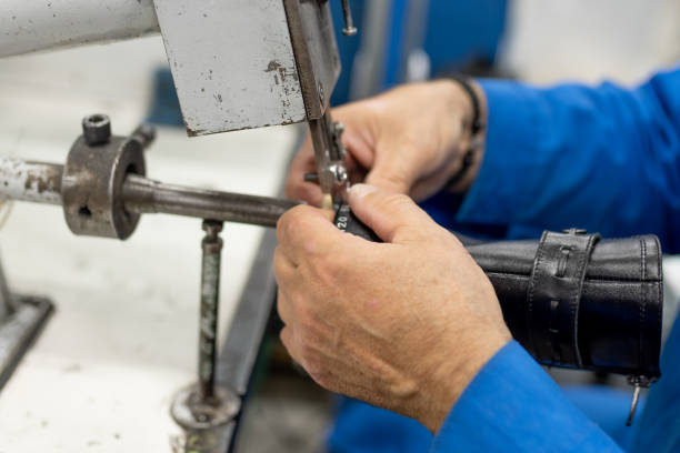 istock Machine for trimming excess sticking lining. Shoe production. 1200299149