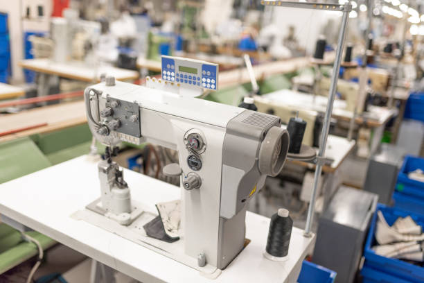 istock Industrial sewing machine in the work shop. Shoe manufacturing. 1200299231