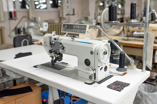 Industrial sewing machine in the work shop. Shoe manufacturing. For any purpose.