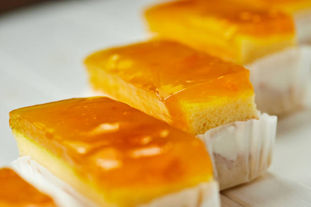 istock Orange jelly sponge cakes on wooden background 1200300182