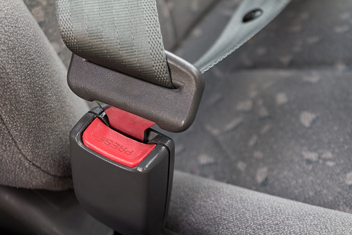 car three-point safety belt, buttoned, the concept of road safety, life and health of the driver and passengers, compliance with traffic rules
