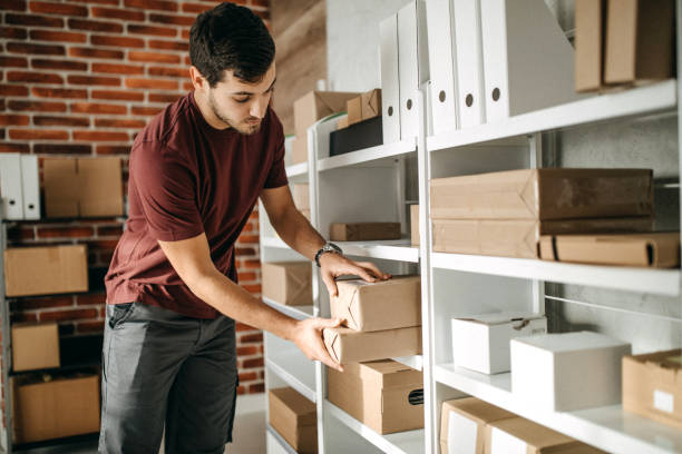 istock Delivery person carrying boxes for despatch 1200301382