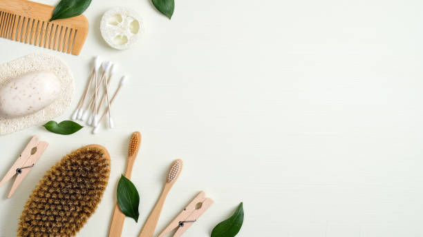 istock Zero waste bathroom accessories. Eco store banner template with bamboo toothbrushes, hair comb, bath peeling brush, luffa sponge, handmade soap, cotton ear sticks. Beauty and SPA treatment concept 1200303034