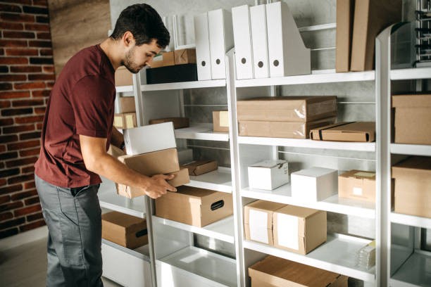 istock Delivery person carrying boxes for despatch 1200304081
