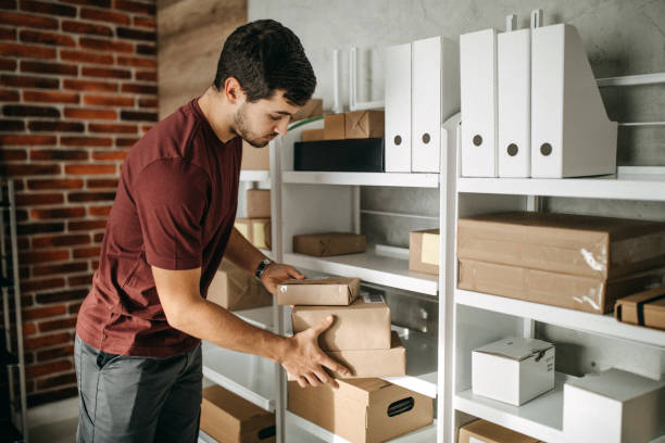 istock Delivery person carrying boxes for despatch 1200304306