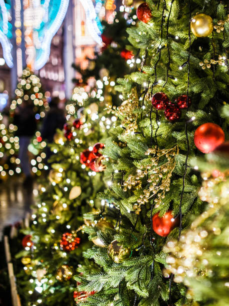 istock Decorated spruce branches swith balls, flowers, with burning lights 1200305562