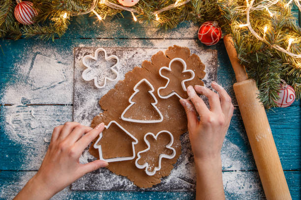 istock Photo of human hands, rolling pin, dough, spruce branches 1200308346