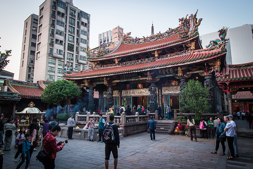 Taipei, Taiwan - Dec 16 2019: \nLungshan Temple, Chinese folk religious temple in Wanhua District, in evening. It was built in 1738 by settlers from Fujian during Qing rule in honor of Guanyin.