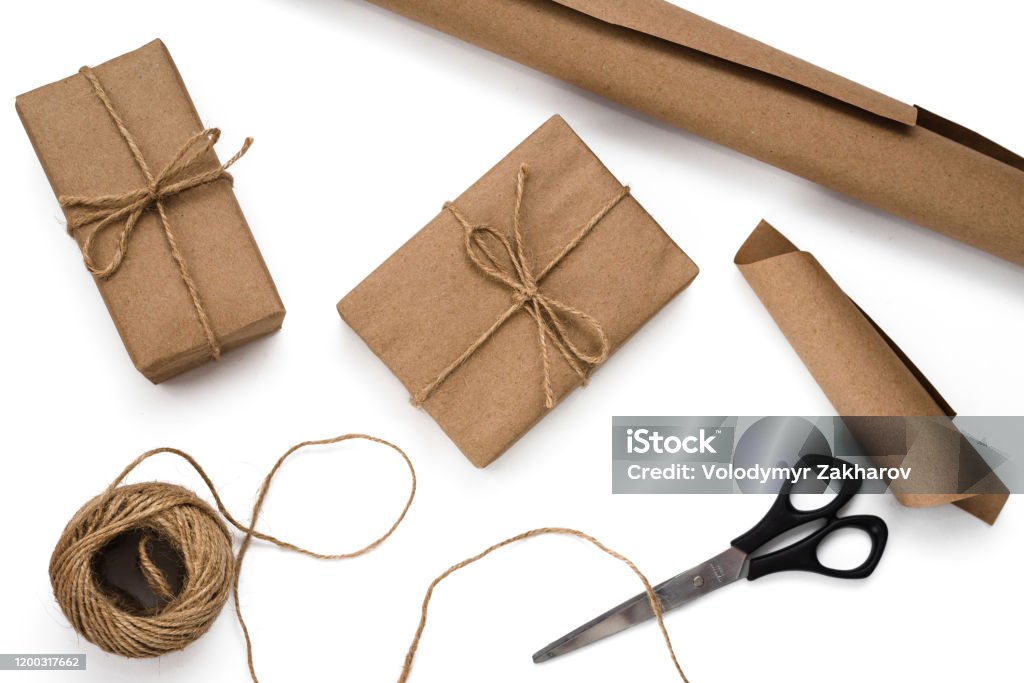 Gift Wrapping Process In Recycled Paper Gift Boxes Skein Of Twine Roll Of  Brown Paper Scissors On White Background Stock Photo - Download Image Now -  iStock