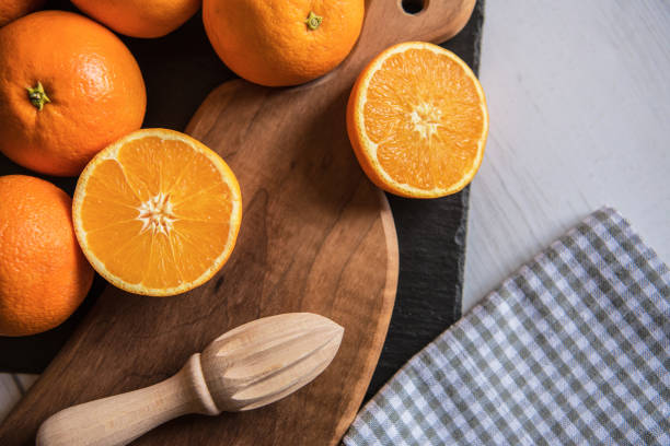 Fresh Juicy Oranges on Wooden Cutting Board stock photo
