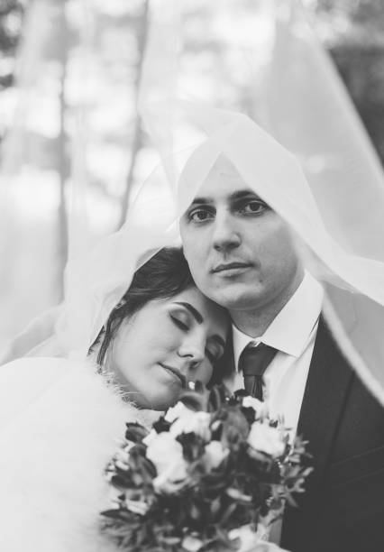 istock Happy bride and groom under a veil 1200319984