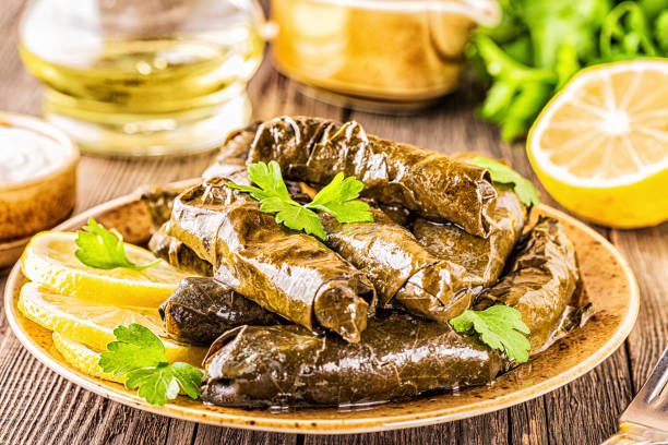 istock Dolma, stuffed grape leaves with rice and meat on dark background, selective focus 1200324891