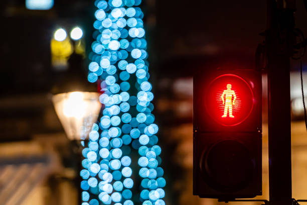 istock Pedestrian semaphore with green light and defocused Christmas tree lights in the background 1200325058