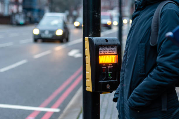 istock Crosswalk button for pedestrian with light warning on a defocused background , London, UK 1200325105
