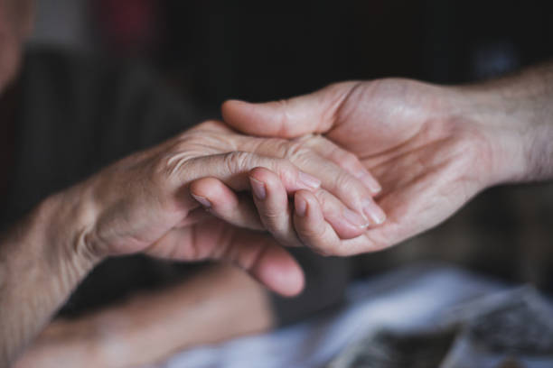 istock Holding hand -  grandson and grandfather 1200326374