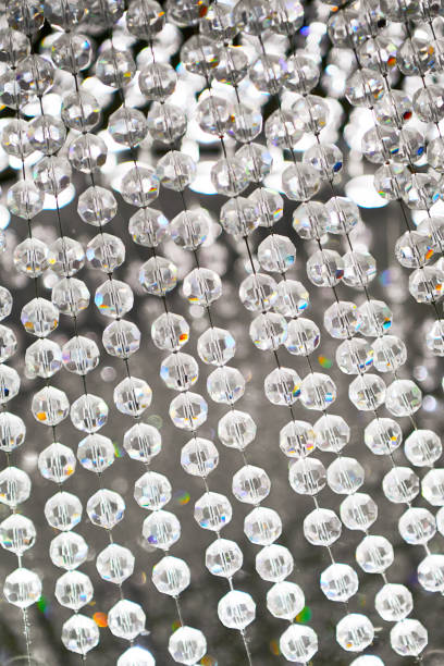 istock Hanging lined-up bright crystal balls of a lamp 1200327601