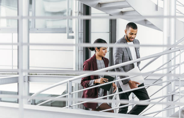 istock Business people discussing on the staircase 1200329993